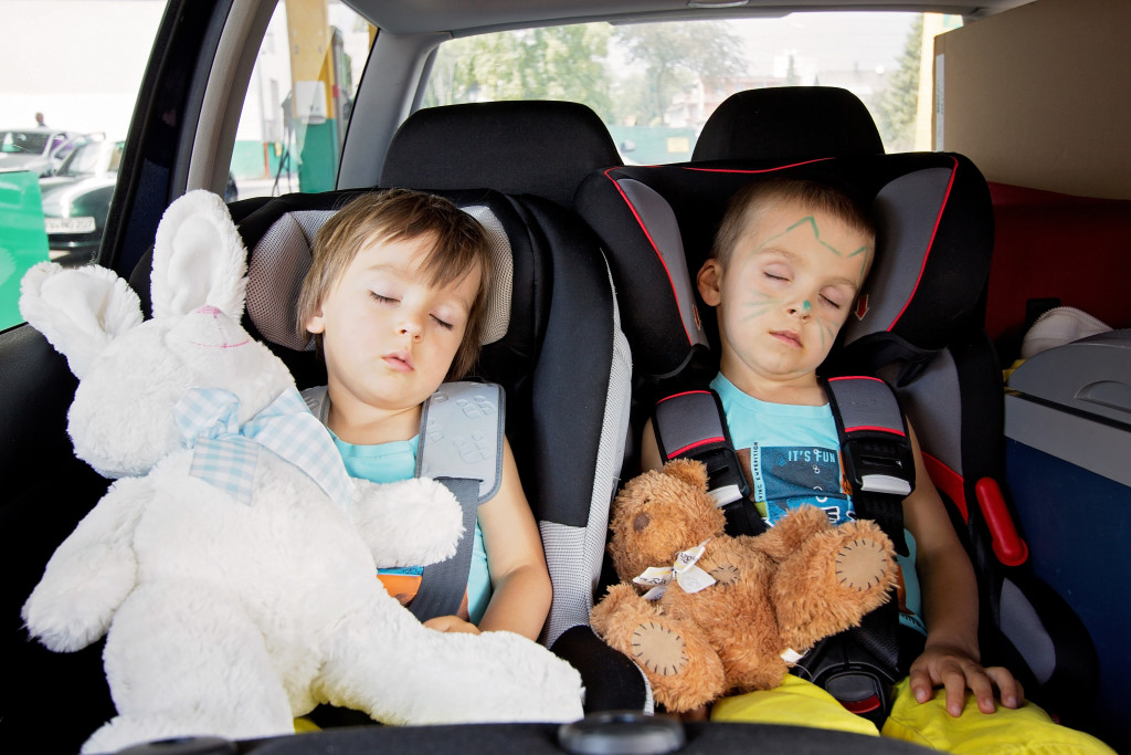 Two boys in car seats, travelling